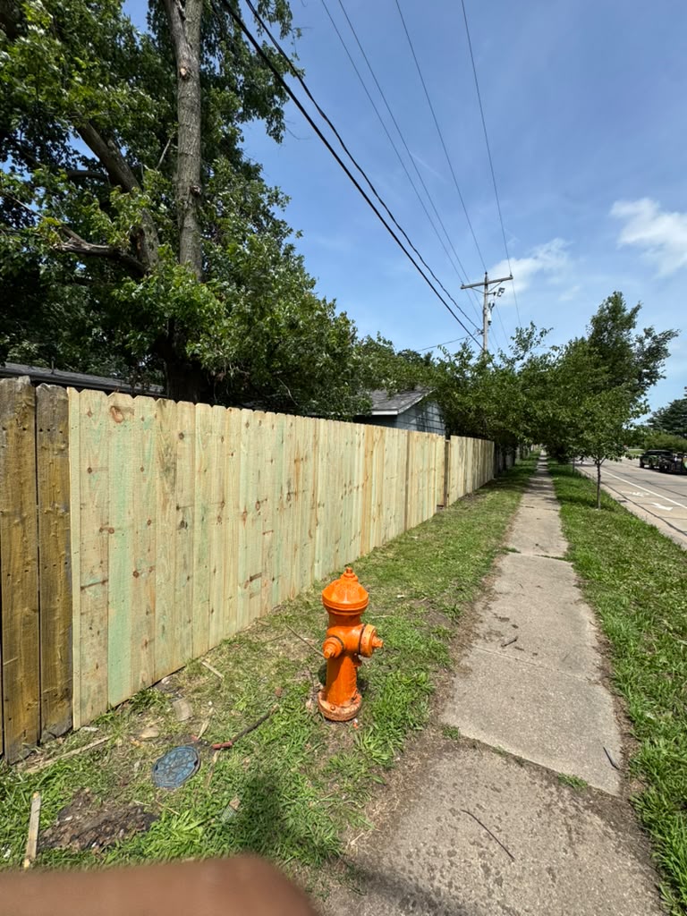 Finished wood fence run along property line