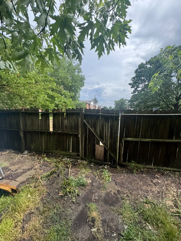 Old weathered fence before replacement