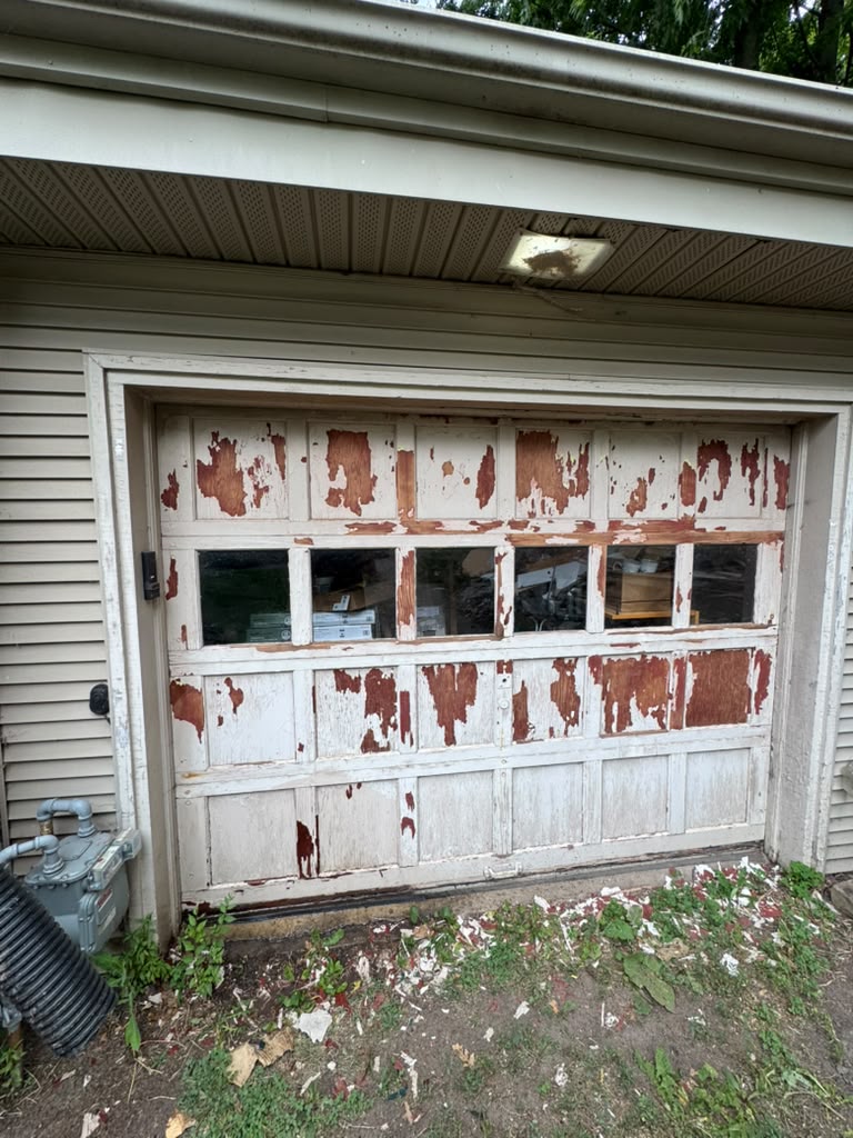 Garage door before repaint, showing peeling paint